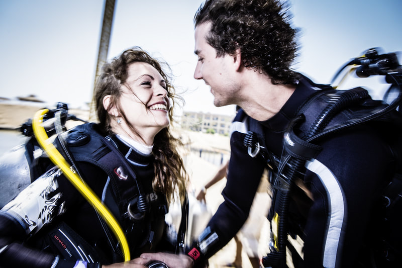 Photo of a couple looking at each other lovingly during their open water course.